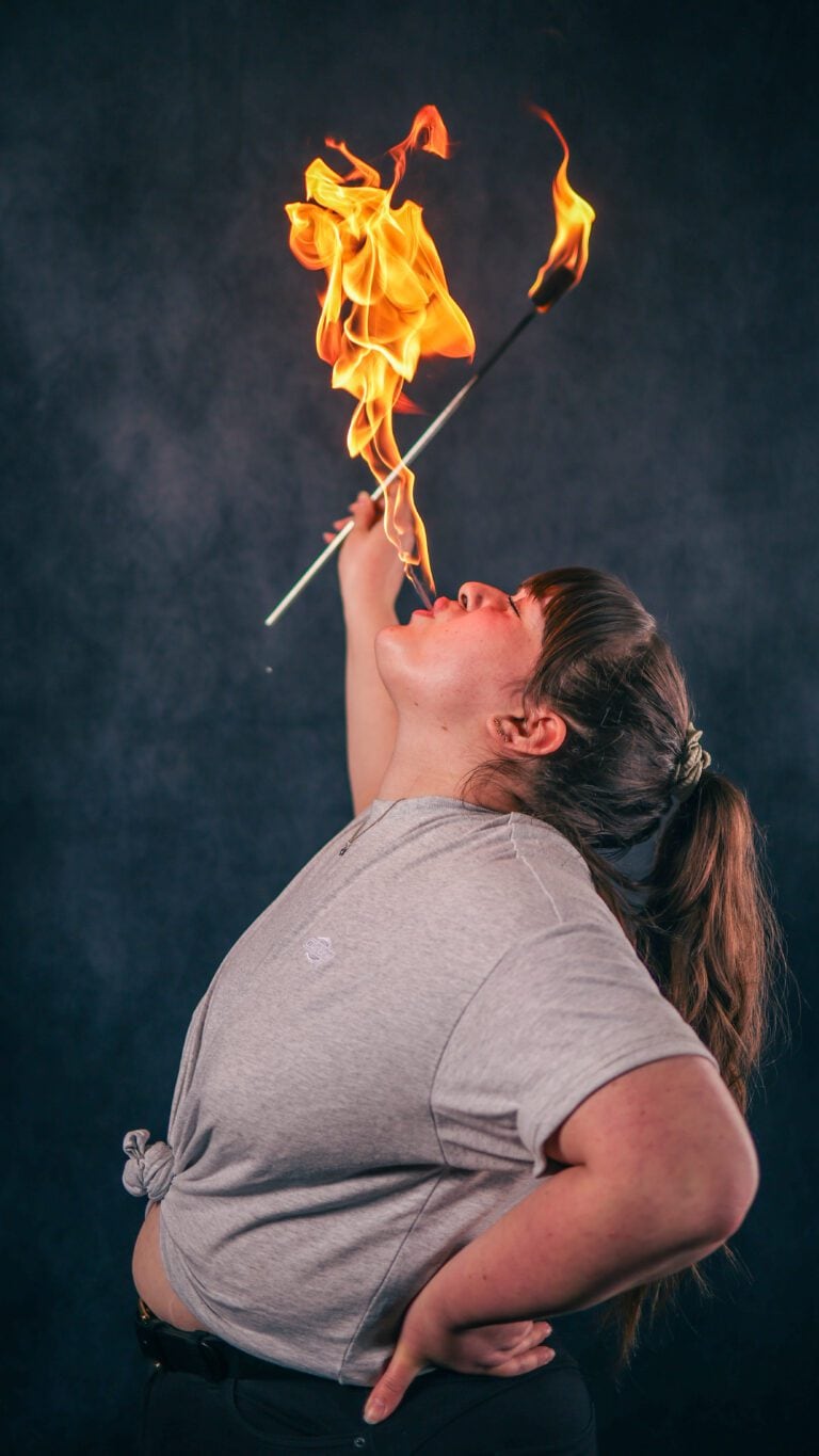Fire eating workshop student performing a fire eat during training