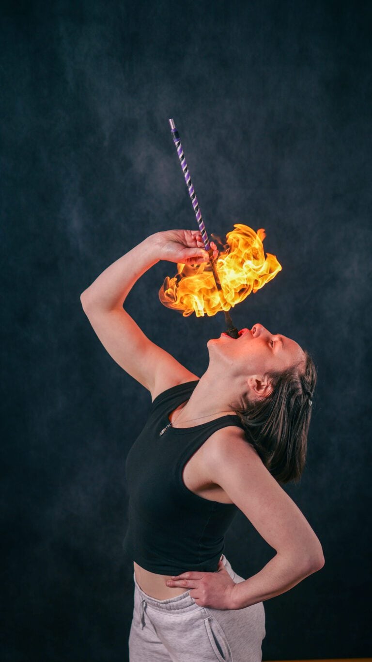 Workshop participant practising fire breathing techniques safely