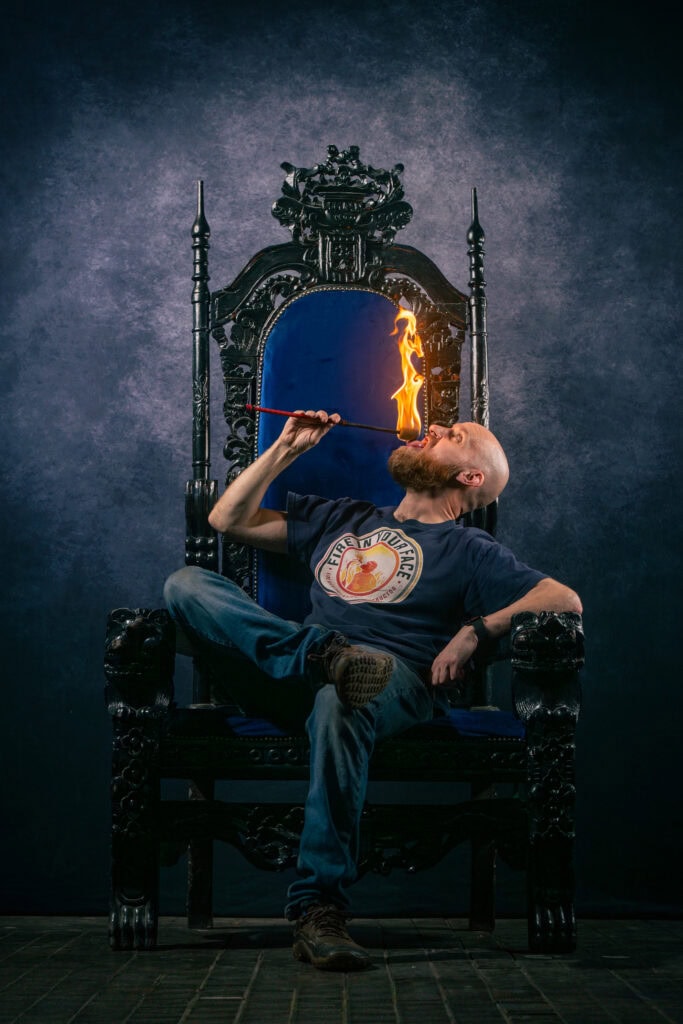 Tom Makinson, founder of Fire In Your Face, demonstrating fire eating